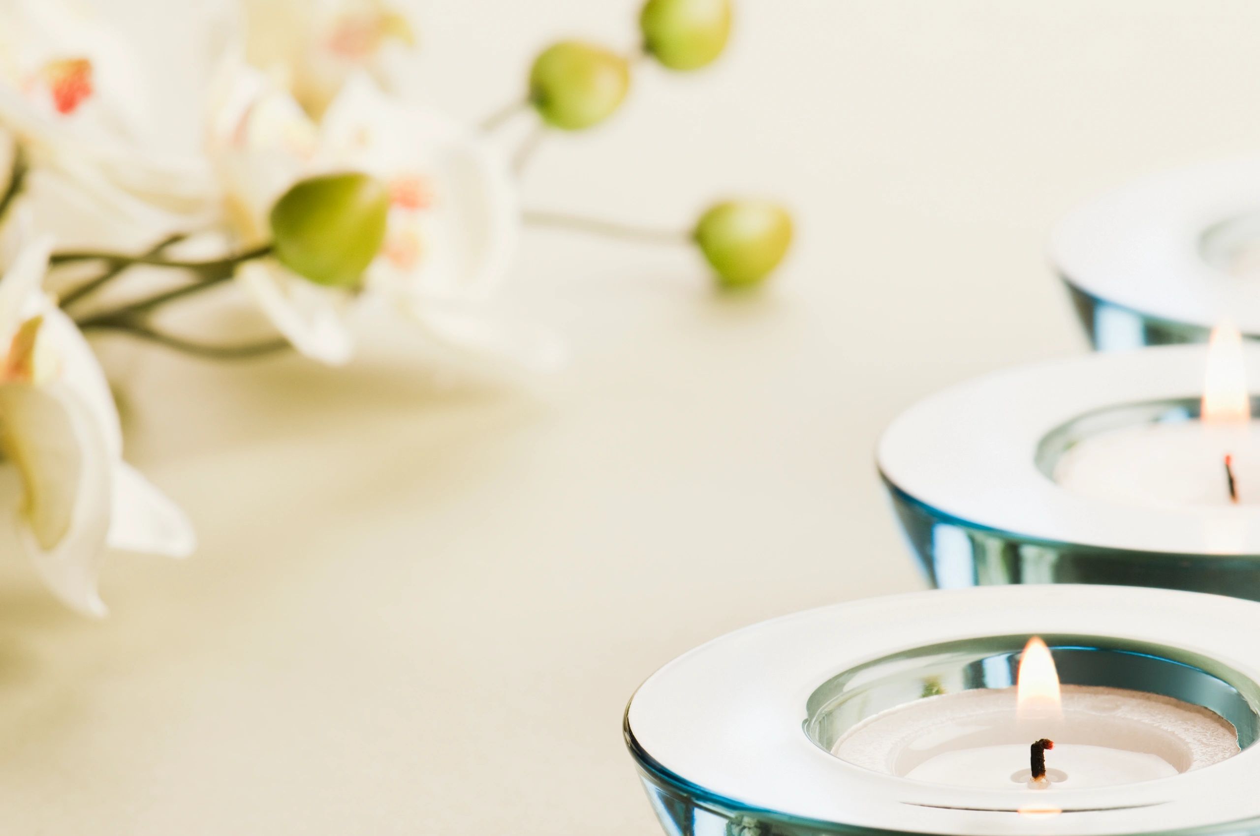 White orchid with glass tea light candles
